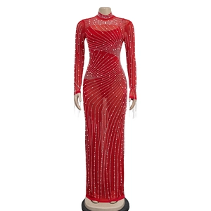 Detail of red mesh dress showing shimmering rhinestones in a wave pattern on sheer fabric
