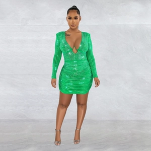 Detail of emerald green ruched dress with sparkling rhinestones and cutout design