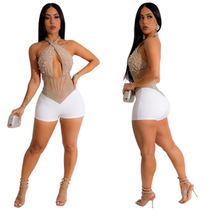 Detailed view of the white mesh romper with intricate pearl and rhinestone embroidery