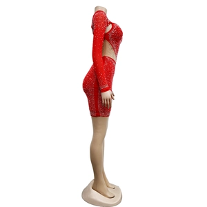 Detail view of red mini dress with sheer mesh side panels and shimmering crystals