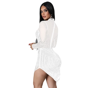 Detail of white mesh mini dress with sparkling silver rhinestones and asymmetric hemline