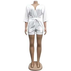 Detail of white V-neck romper featuring a drawstring elastic waist and 3/4 sleeves