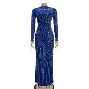 Detail of royal blue mesh dress showing intricate hand-beaded pearls and long fringe sleeves
