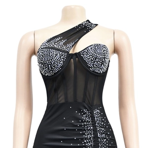 Detail of black asymmetric mini dress with rhinestone cups and sheer mesh waist panel