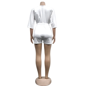 Back view of a white V-neck romper with half sleeves and an elastic waist detail