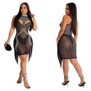 Detail of black mesh bodycon dress featuring rhinestone patterns and long fringe tassels