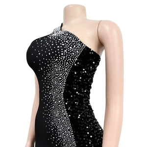 Detail of black one-shoulder dress with sparkling silver rhinestones and sequins