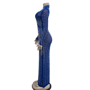 Detailed side view of sapphire blue mesh gown with sparkling rhinestones and pearls
