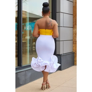 Back view of yellow tube top and white mermaid skirt with large ruffled hem detail
