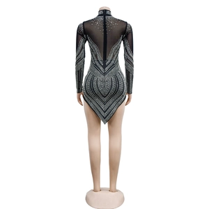 Detail of black mesh bodysuit featuring sparkling silver rhinestones and a high collar