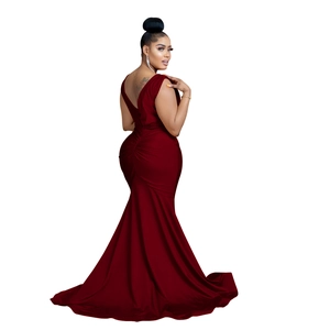 Detail of burgundy backless V-neck maxi dress featuring pleated fishtail hem and long train