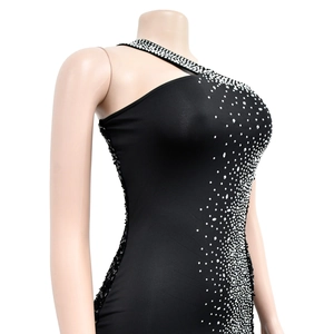 Detail of a black one-shoulder dress featuring silver rhinestones and sequins in a gradient