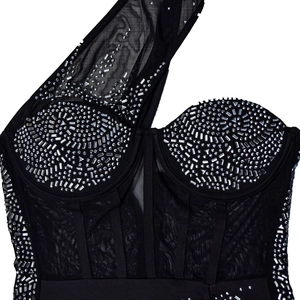 Detail of black one-shoulder mesh dress with silver rhinestones and boning structure