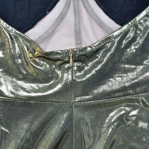 Detail of invisible zipper on sleeveless metallic dress with contrasting inner lining