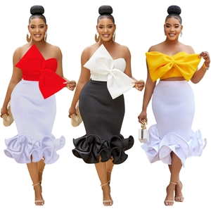 Close-up of the two-piece set featuring a large bow tube top and ruffled fishtail skirt