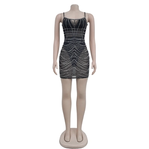 Detailed close-up of sparkling rhinestones and mesh patchwork on a mini dress