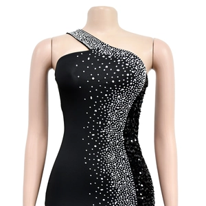 Detail of silver rhinestones and black sequins on a one-shoulder bodycon evening gown
