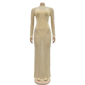 Close-up of sheer mesh maxi dress featuring intricate white pearls and rhinestone patterns