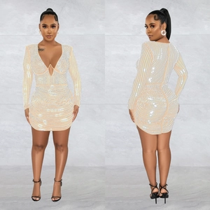 Detail of slim fit beige long sleeve dress with silver rhinestones in striped patterns