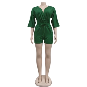 Detail of forest green V-neck romper featuring a drawstring waist and medium sleeves