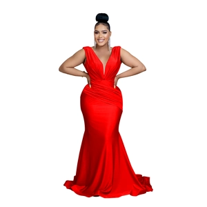 Detail of red V-neck evening gown featuring elegant ruched bodice and mermaid hem design