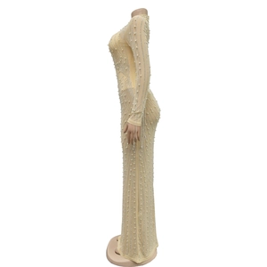 Detail of sheer mesh maxi dress showing hand-applied pearls and radiant rhinestones