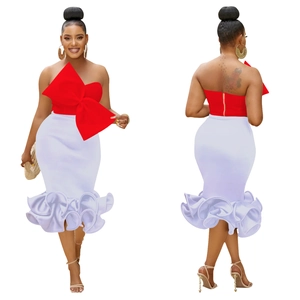 Detail view of red strapless top with oversized bow and white mermaid skirt with ruffles