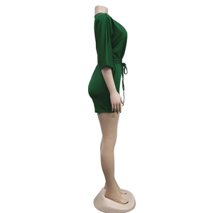 Side view of dark green short romper featuring a drawstring waist and elastic slim fit