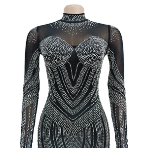 Detail of black mesh bodysuit with high neck, long sleeves and silver rhinestone patterns
