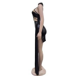 Detail view of black cutout mini dress with a dramatic floor-length side cape streamer