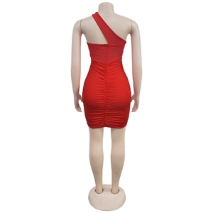 Detail view of red bodycon dress featuring back zipper and ruched seam on elastic fabric