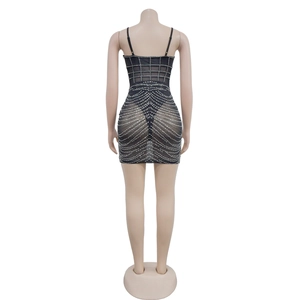 Detail of black mesh mini dress featuring sparkly rhinestones and thin shoulder straps