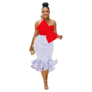 Detail of red bow strapless top and white high waist fishtail skirt with ruffled hemline