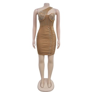 Detail of camel bodycon dress featuring rhinestone mesh, corset boning and ruched fabric