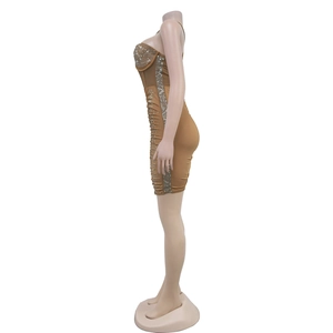 Detail of tan bodycon dress with silver rhinestone accents and ruching on the sides