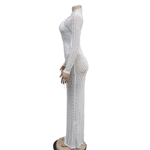 Detail of white mesh dress featuring elegant rhinestone stripes and pearl embellishments