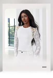 Detail of white long sleeve top with floral lace sleeves and colorful embroidery details