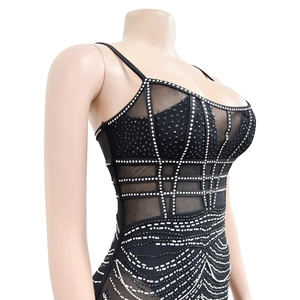 Close-up of black mesh mini dress featuring sparkly rhinestones and thin shoulder straps