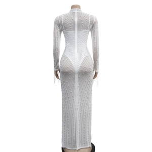 Detailed close-up of white mesh fabric featuring radiant faux pearl embellishments