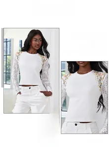 Close-up of white rib-knit top with lace sleeves and colorful floral embroidery
