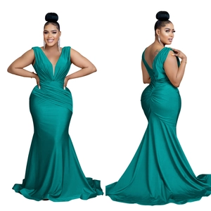 Detailed view of the emerald green satin v-neck evening gown with elegant waist ruching