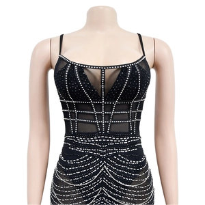 Detail of black rhinestone mesh dress showing intricate geometric silver stud patterns