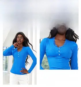 Detailed view of lace trim collar and resin buttons on a royal blue viscose long sleeve top