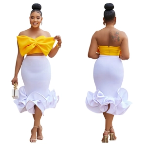 Detail of yellow bow tube top and white high-waist mermaid skirt two-piece set