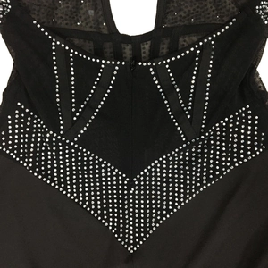 Detail of sheer black mesh bodice with intricate silver rhinestone geometric patterns