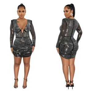 Detail of black mesh mini dress featuring shimmering rhinestones and deep V-neckline