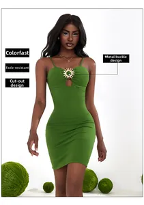 Detail of green bodycon dress featuring hollow-out design and gold sun buckle