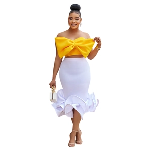 Detail of yellow oversized bow tube top paired with white mermaid skirt set for women