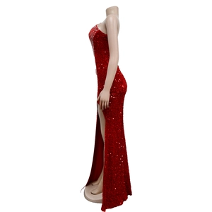 Detail of red sequined evening gown featuring silver rhinestone embellishments and high side slit