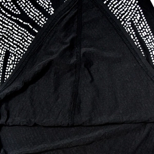 Macro detail of black mesh dress featuring dense silver rhinestones and interior seam work